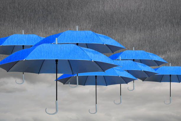 umbrella and rain In the sky is gray, overcast and rainy. There are many blue umbrellas to protect against wet. emergency shelter photos stock pictures, royalty-free photos & images