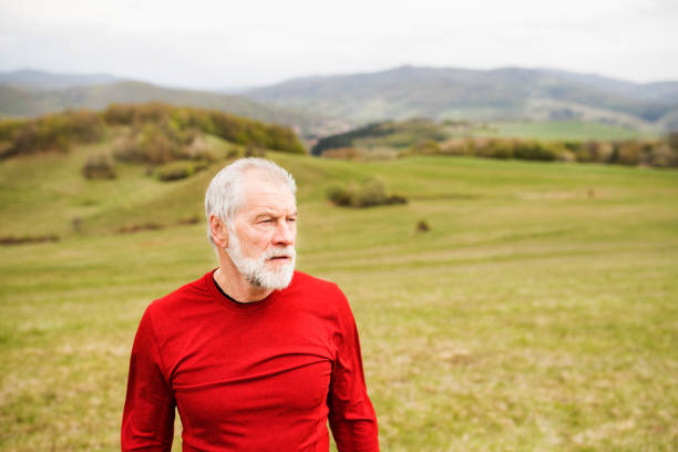 istock Active senior runner in red sweatshirt in nature resting. 822724876