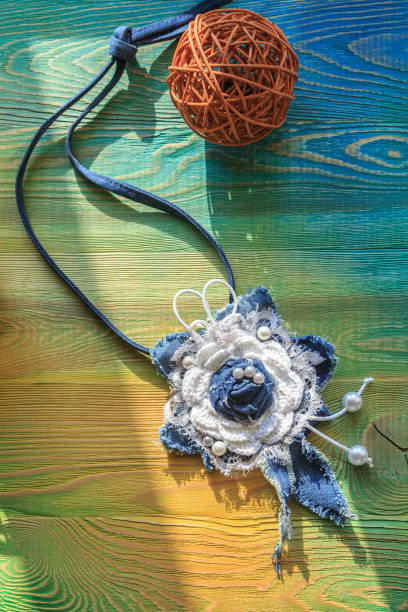 istock Jeans pendant handmade on a wooden surface 822725992