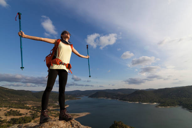 istock Successful woman backpacker enjoy the view at mountain peak 822732598