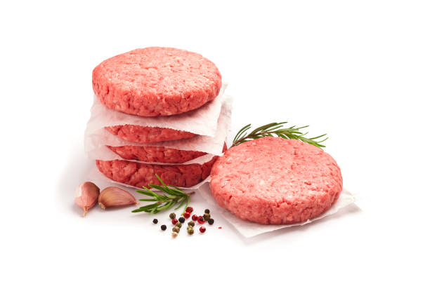 Raw hamburger patties against white background