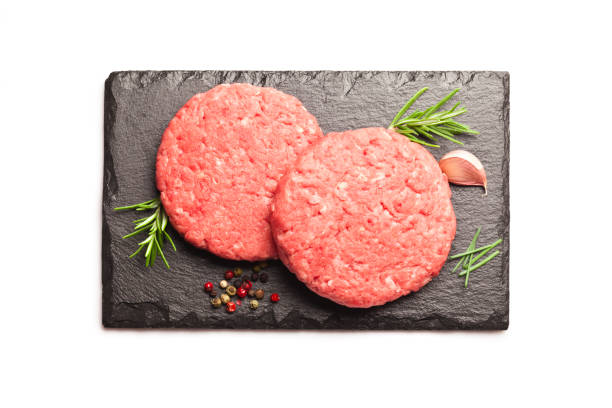 istock Raw hamburger patties against white background 822732962