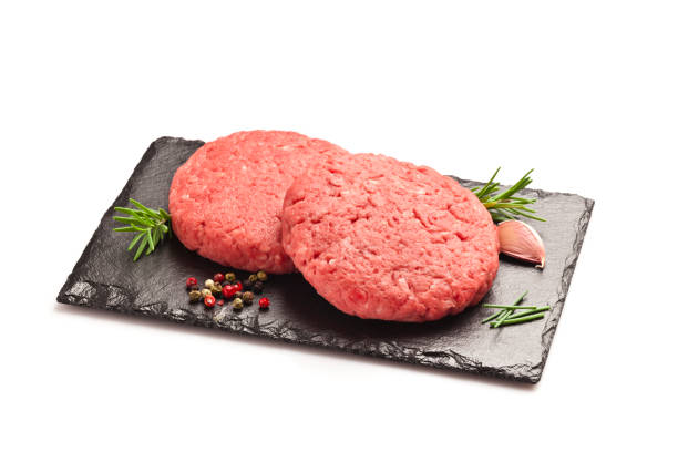 istock Raw hamburger patties against white background 822733210