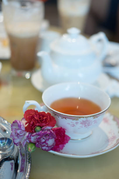 istock Cup of hot tea with flower decor on saucer 822733328