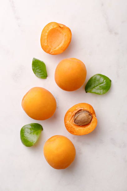 Apricots on marble background viewed from above. Fresh and healthy fruit. Top view stock photo