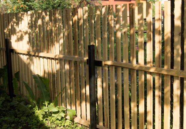 nuova recinzione picchetto e pali di metallo nero, costruiti in giardino - picket fence grass gardens nature foto e immagini stock