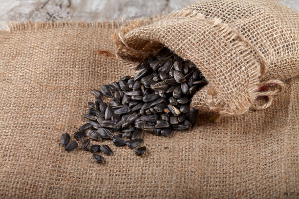 istock Sunflower seeds in a sack on burlap. 822758214