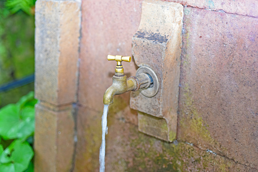 Old retro outdoors water faucet. Located in garden