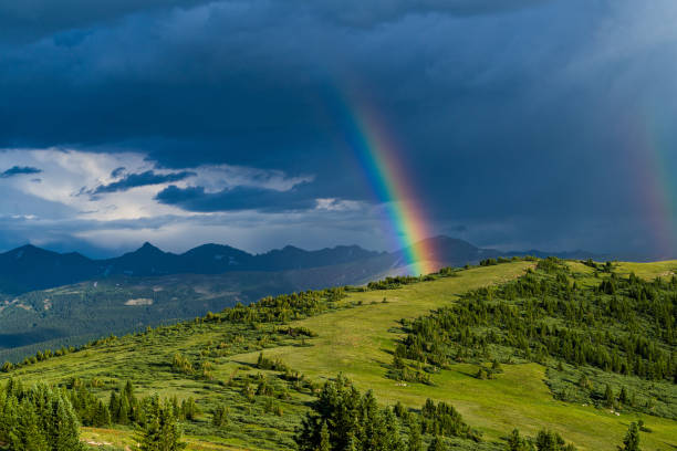 Rainbow Over Scenic Mountain Landscape Rainbow Over Scenic Mountain Landscape - Dramatic sunny light looking toward Tenmile Range. Summit County, Colorado USA. colorado photos stock pictures, royalty-free photos & images