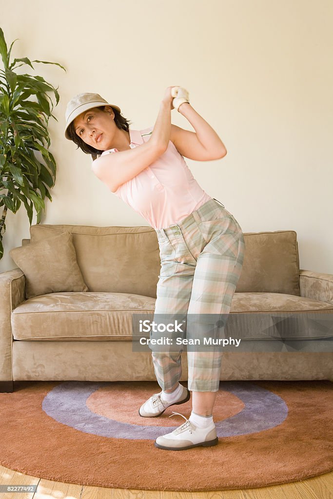 Mature woman pretending to play golf  Golf Swing Stock Photo