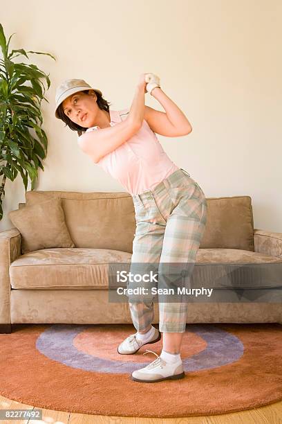 Mature Woman Pretending To Play Golf Stock Photo - Download Image Now - Golf Swing, Domestic Life, Golf