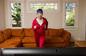 Woman exercising in front of television