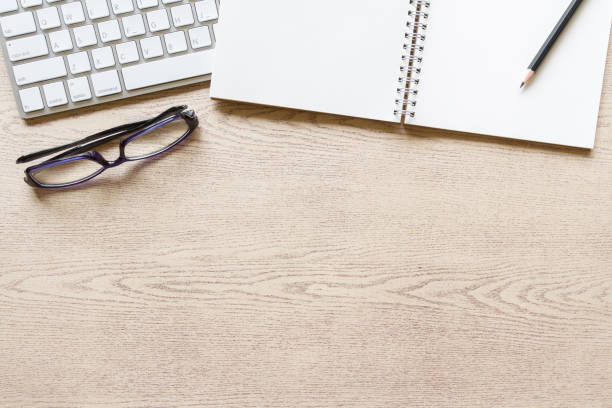 istock top view wooden office desk with computer and supplies 822794738