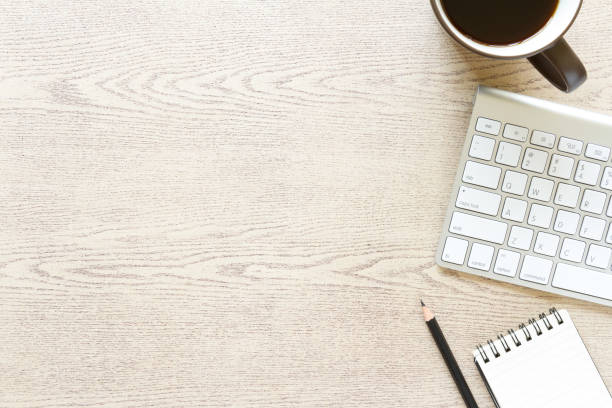 istock top view wooden office desk with computer and supplies 822794812