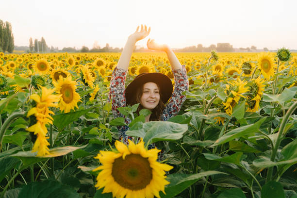 istock Woman dancing in the sunflower field 822802906