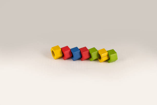 istock Colorful wooden toy nuts arranged in line 822806110