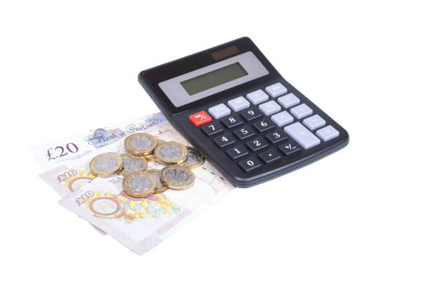 istock Pile of pound bills and coins with calculator 822831556