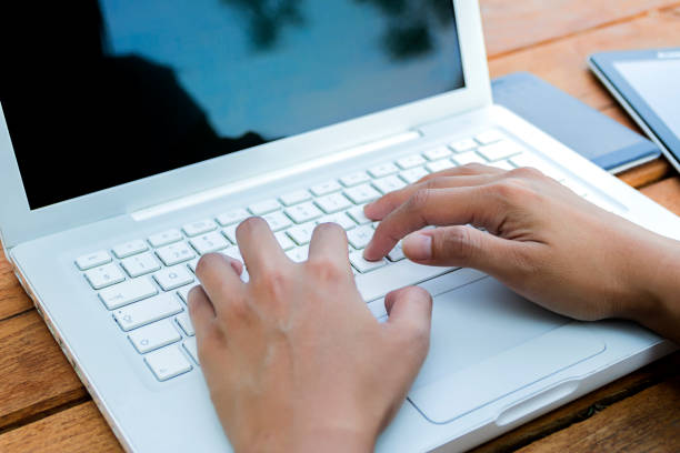 istock Person Using Laptop Computer On park Wooden Desk 822848774