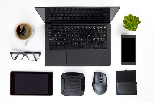Various Devices Arranged On White Office Desk