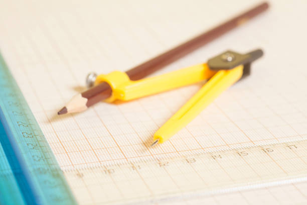 istock Yellow Drawing compass with pensil  and rulers on graph paper.Engineering concept. 822873978
