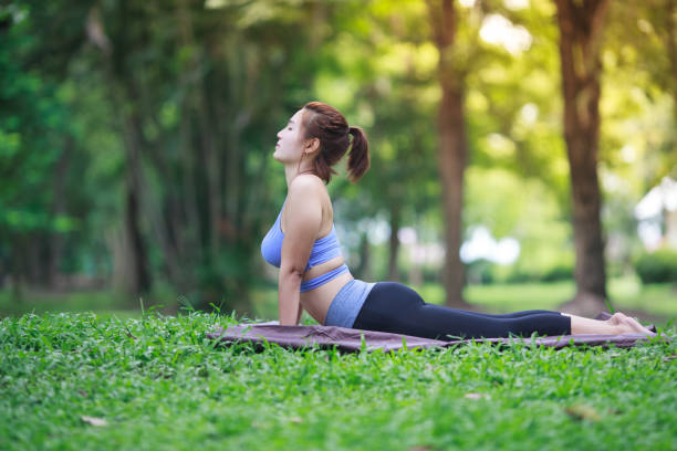 istock Young woman doing yoga in the park 822874608