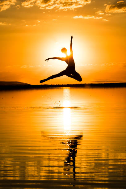 istock young ballet dancer dancing on the lake in the evening 822874660