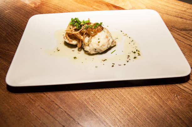 istock Dumpling rolled in cheese with onion decoration on plate 822879842