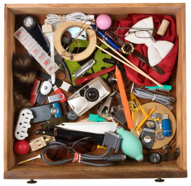Photo of Drawer full of junk, of various household items. On a white background with clipping path