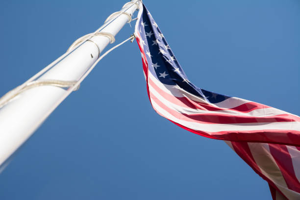 istock The US flag in blue sky 822881054