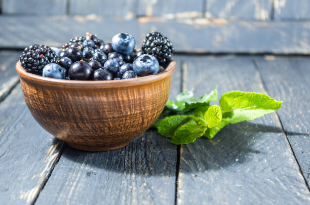 istock Sweet forest berries in a clay bowl. 822912402