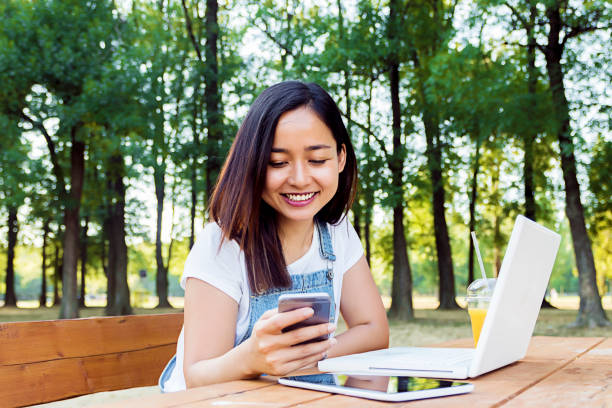 istock Cute indonesian girl using smartphone 822917338