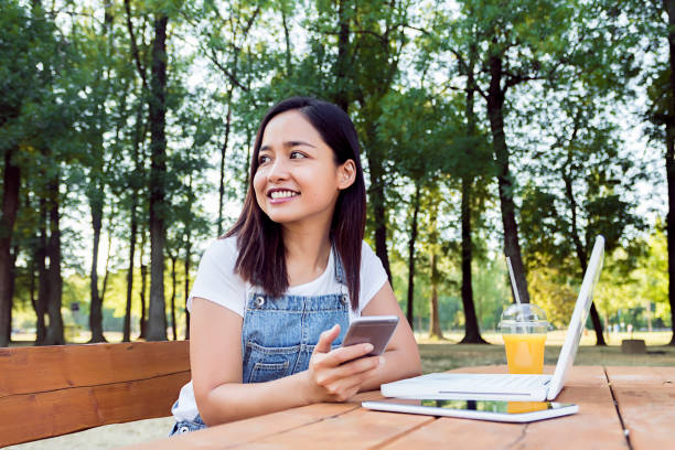istock Cute indonesian girl using smartphone 822917504