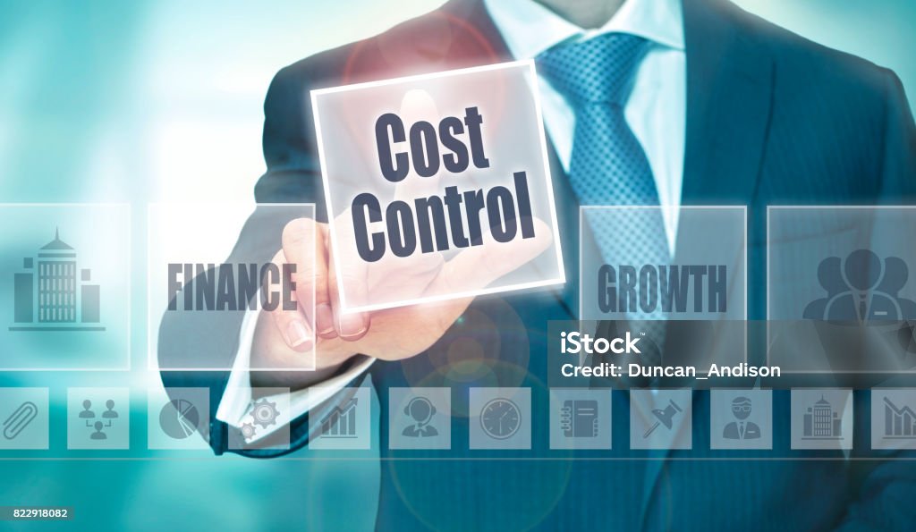 A businessman selecting a Cost Control Concept button A businessman selecting a Cost Control Concept button on a clear screen. Expense Stock Photo