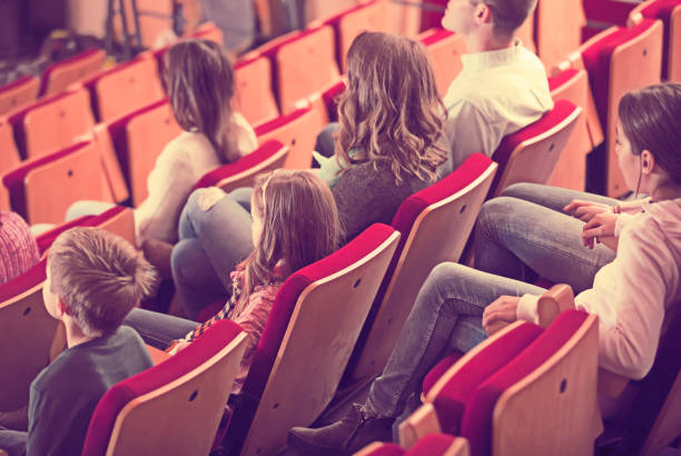 istock Cheerful group expecting movie to begin 822918718
