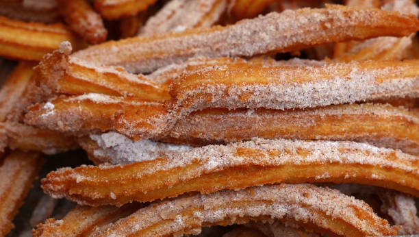 istock Sweet fresh churros snack with sugar close up 822923654