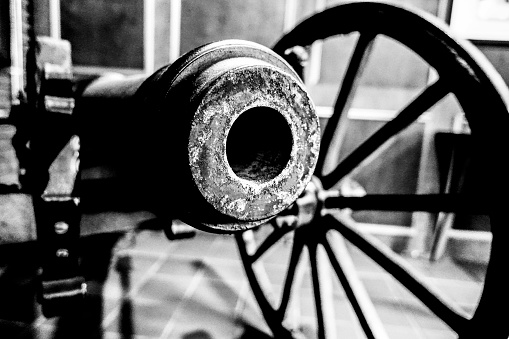 an antique cannon standing still.