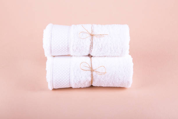 istock Two white canvas rolls rolled up. Pink background. Still life. 822932336