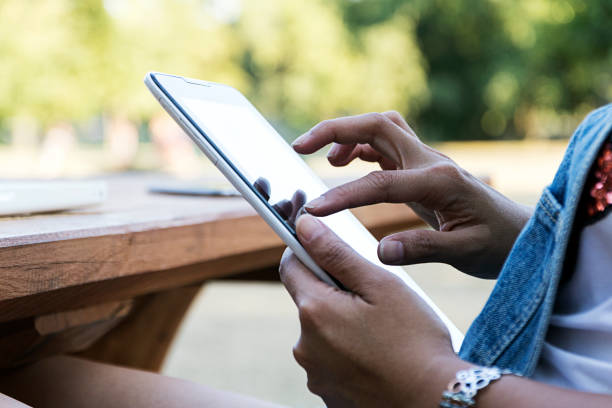 istock Indonesian girl using tablet pc in the park 822932362