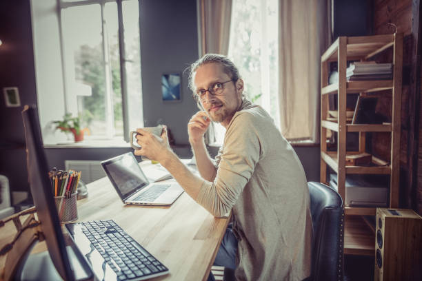 istock Side view of young freelancer sitting at home office working. 822939974