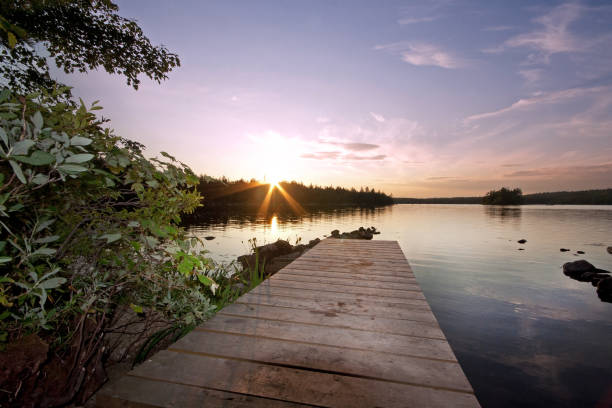 istock wooden pier at sunset by lake 822960702