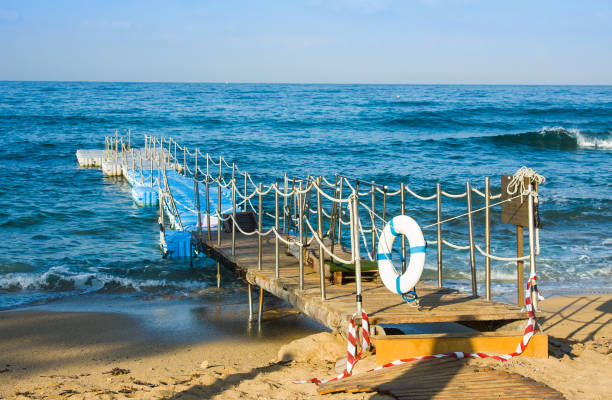 istock Life buoy hanging on pier and sea background 822961598