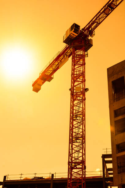 istock A tower crane next to a concrete building at sunset 822966028