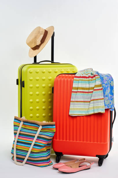 istock Closed suitcases and summer clothes. 822972968