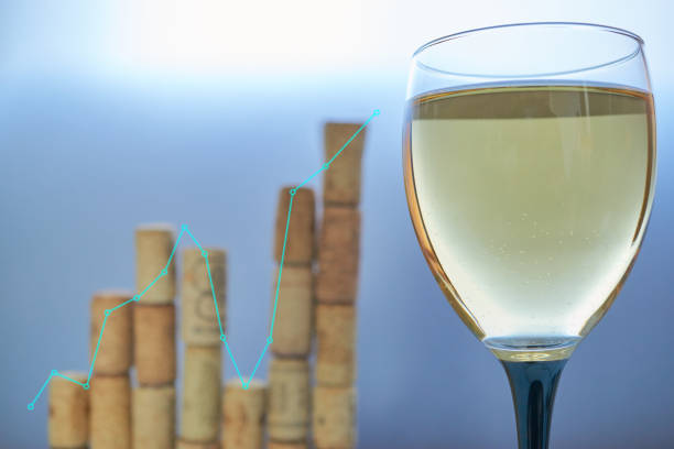 graph chart which depict seasonal wine sales made from corks with wineglass of white wine on foreground