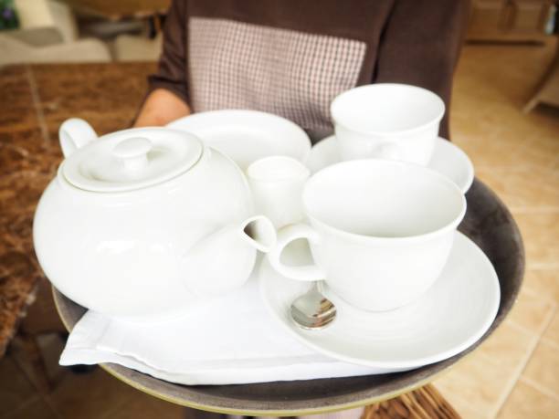 istock Woman serving with tea pot and cup 823032184