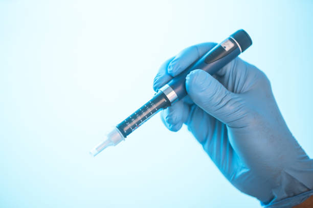 istock scientist with glove holding insuline pen for injection 823046600