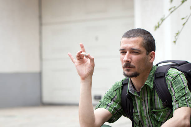 istock Portrait of a lonely, desperate man smoking cigarette 823067892