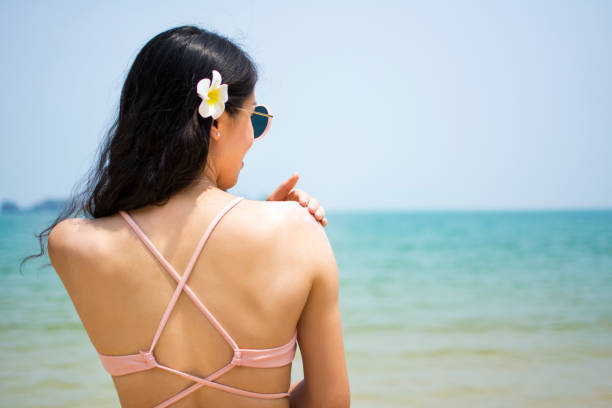 istock Girl applying sun lotion on summer vacation 823073808