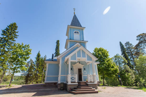 istock Blue church surrounded by forest on a sunny day 823074480