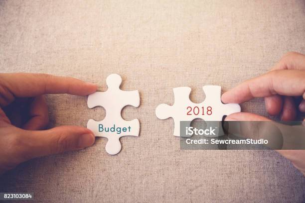 Hands With Puzzle Pieces And Budget 2018 Words Stock Photo - Download Image Now - 2018, Budget, Australia